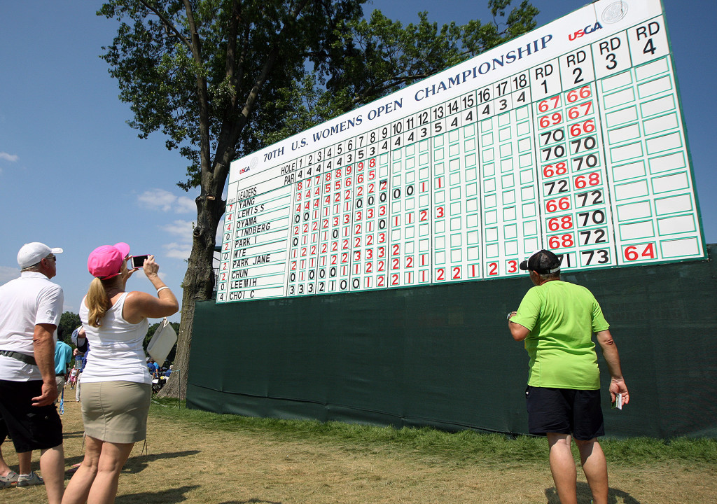 Fans check the scores at the 18th hole leader board, during third day action of the 70th US Women's Open at Lancaster Country Club Saturday July 11, 2015. (Photo/Chris Knight)