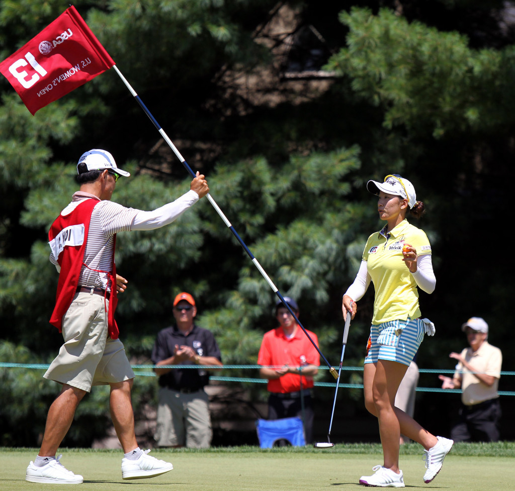 Chella Choi, right, acknowledges the crowd after a birdie on the 13th hole, during third day action of the 70th US Women's Open at Lancaster Country Club Saturday July 11, 2015. (Photo/Chris Knight)