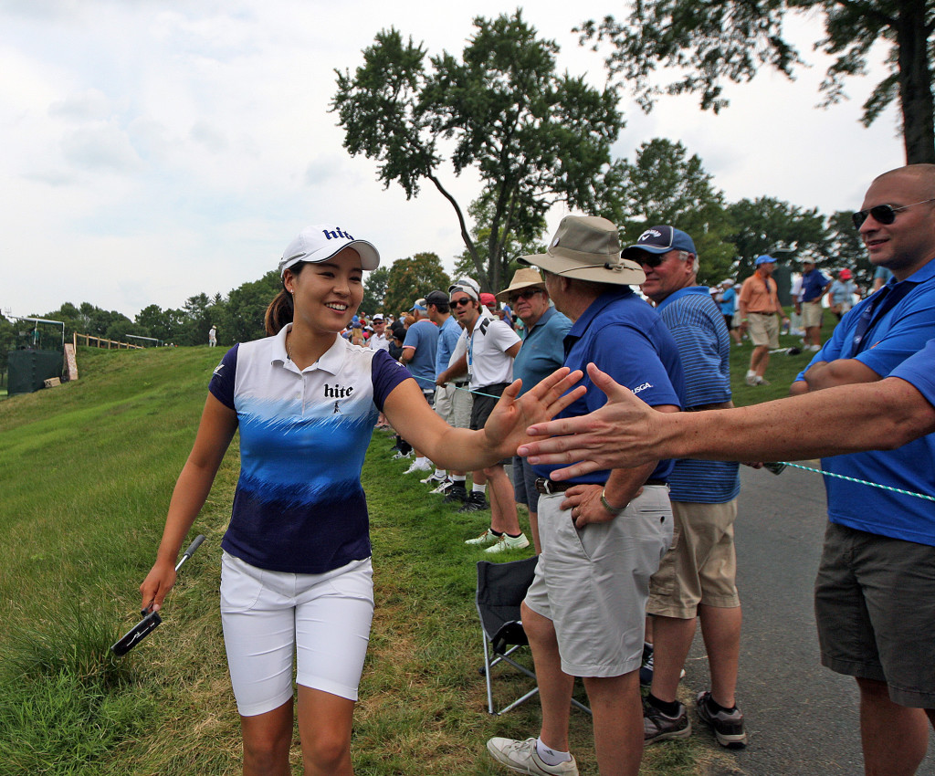 In Gee Chun, slaps hands with fans as she makes her way to the 6th green, during final day action of the 70th US Women's Open at Lancaster Country Club Sunday July 12, 2015. (Photo/Chris Knight)