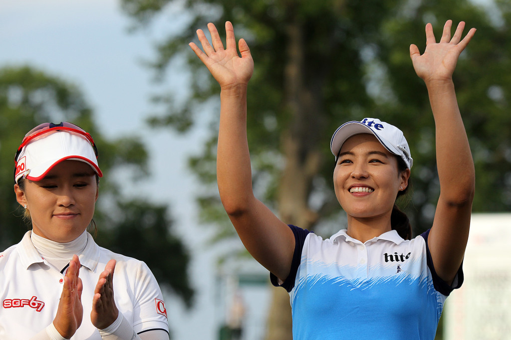 Winner In Gee Chun, right, waves to the crowd as runner up Amy Yang, looks on, during the trophy presentation of the 70th US Women's Open at Lancaster Country Club Sunday July 12, 2015. (Photo/Chris Knight)