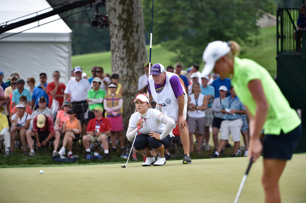 Amy Yang and David Poitevent line up a birdie putt on the sixth hole as Stacy Lewis waits to put during the final round of the US Women's Open at Lancaster Country Club on Sunday, July 12, 2015. (Photo/Suzette Wenger)