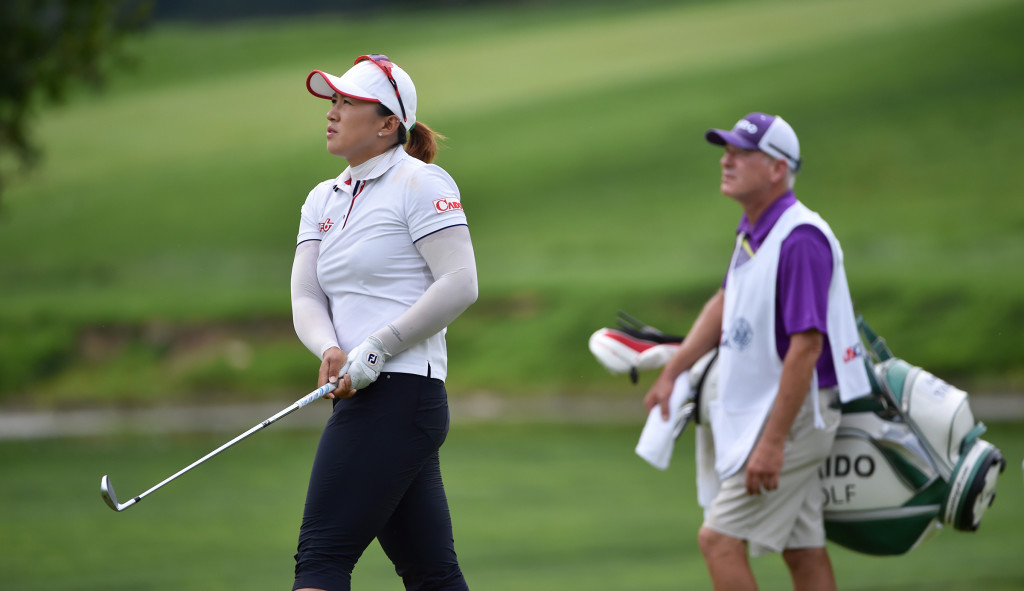Amy Yang and her caddie David Poitevent watch her second shot into the third hole during the final round of the US Women's Open at Lancaster Country Club on Sunday, July 12, 2015. (Photo/Suzette Wenger)