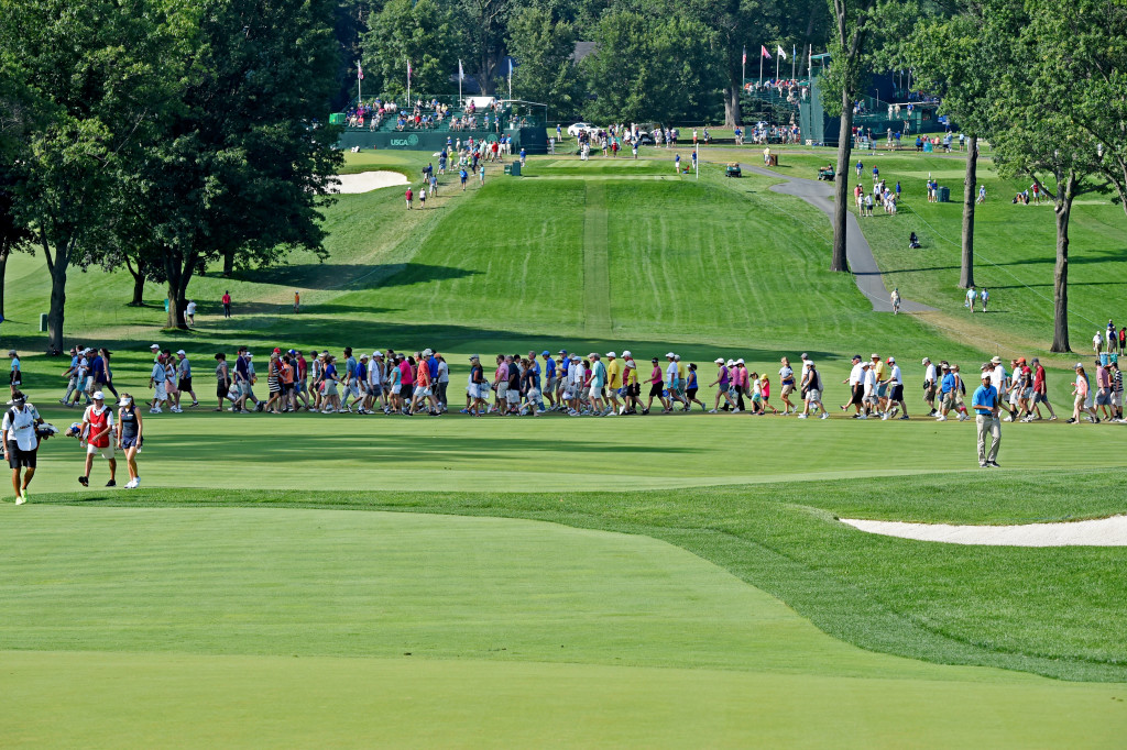 Spectators walk across the fairway on #18 as golfers make their way toward the green in the second round of the U.S. Women's Open Friday.  (Photo/Blaine Shahan)