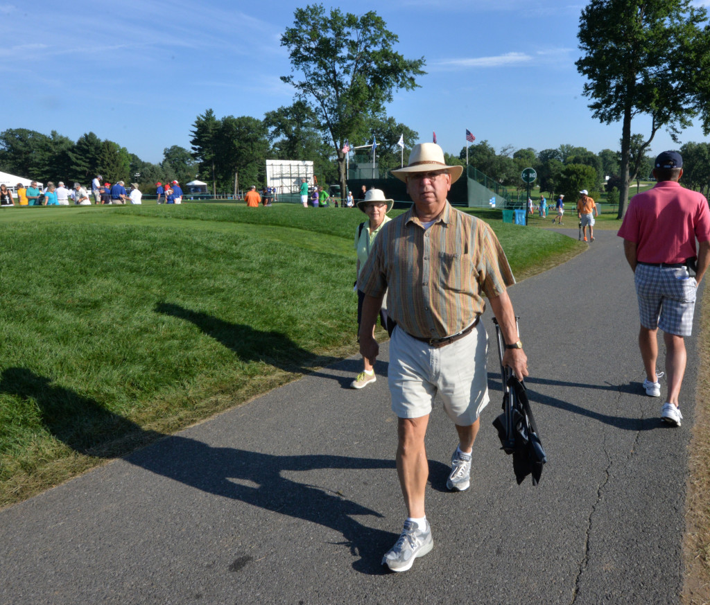 Rick Schoenberber, of Leola, and his wife Donna walk on the pathway that crosses hole #1 at Lancaster Country Club before the start of Round 3 of the U.S. Women's Open Saturday.  Schoenberger, who is a retired East Hempfield Township Police Lieutenant, has been at Lancaster Country Club for every day of the event but plans to watch the finals Sunday from home on television.