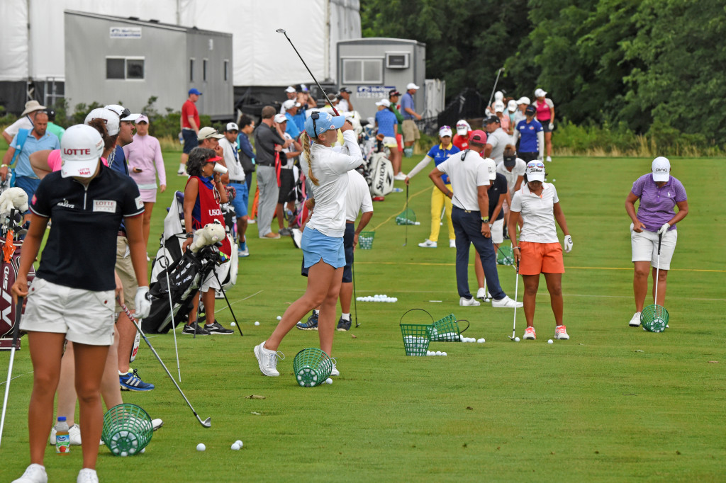 After the passing of a thunderstorm that suspended play in the U.S. Women's Open Thursday afternoon golfers returned to the driving range to continue praticing for the event. The tee area of the diring range used for the U.S. Women's Open was moved forward of where the golfers normally play because of standing water.  (Photo/Blaine Shahan)