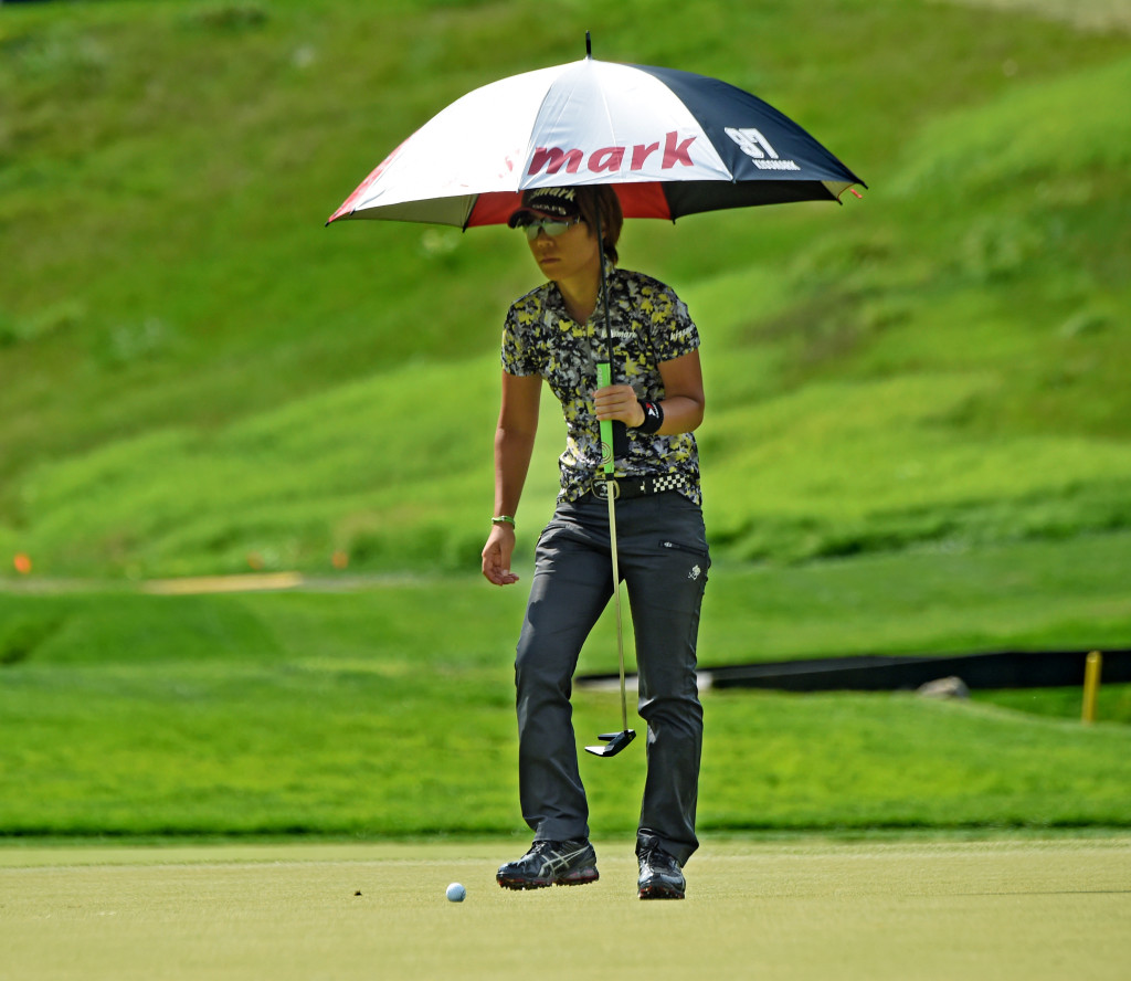Lala Anai shades herself with and umbrella while on the #6 green at Lancaster Country Club in Round 4 of the 2015 U.S. Women's Open Sunday.  (Photo/Blaine Shahan)