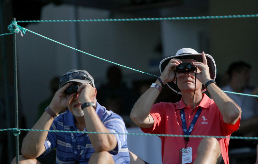 Spectators use binoculars to look down the 18th fairway from the clubhouse during the third round of play in the U.S. Women's Open at the Lancaster Country Club in Lancaster on Saturday, July 11, 2015. (Photo/Vinny Tennis)
